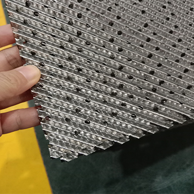 Corrugated filler with metal orifice plate